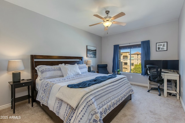 carpeted bedroom with ceiling fan and baseboards