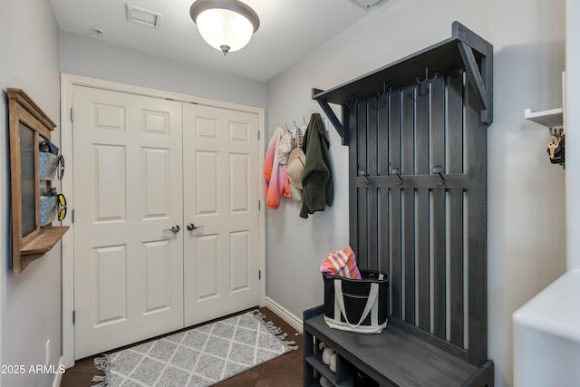 mudroom featuring visible vents, baseboards, and wood finished floors