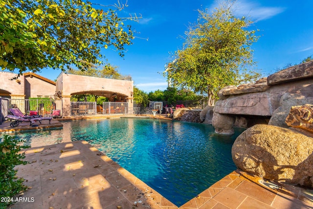 view of swimming pool featuring pool water feature