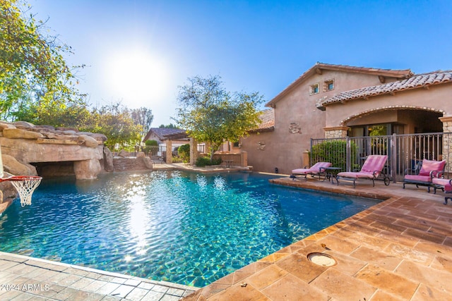 view of swimming pool with a patio and pool water feature