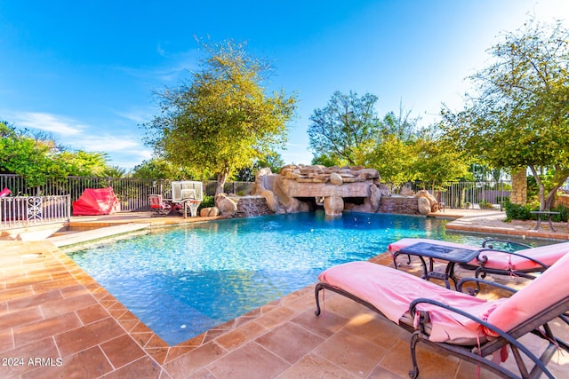 view of swimming pool with a patio area and pool water feature