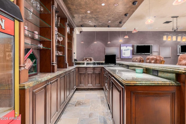 bar with stone countertops and hanging light fixtures