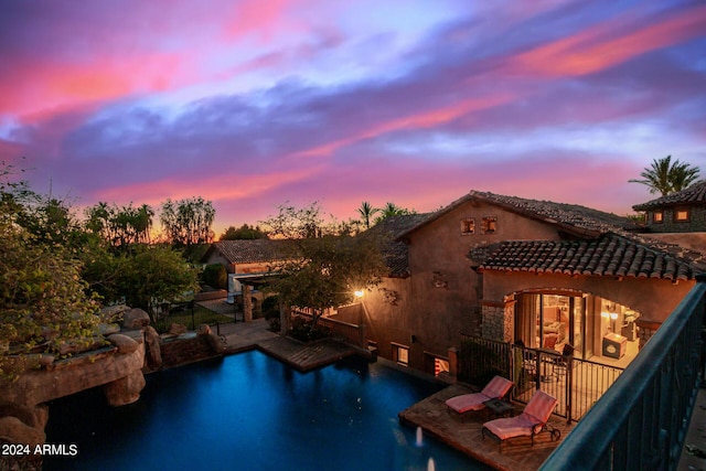 pool at dusk with a water view