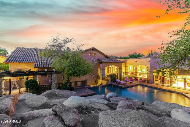 view of pool at dusk