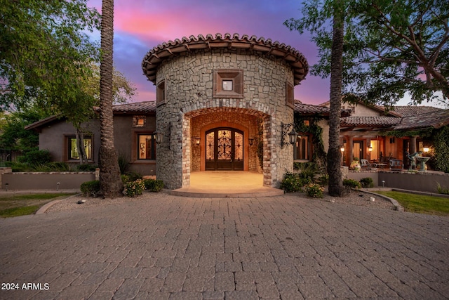 mediterranean / spanish-style house with french doors