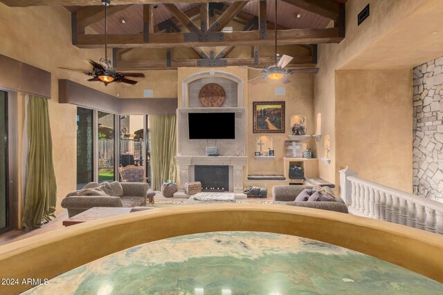 living room with beamed ceiling, wood ceiling, and high vaulted ceiling