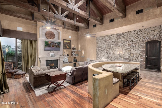 living room with beamed ceiling, hardwood / wood-style flooring, wood ceiling, and high vaulted ceiling