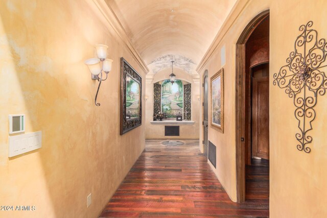 corridor with brick ceiling, dark hardwood / wood-style floors, and lofted ceiling