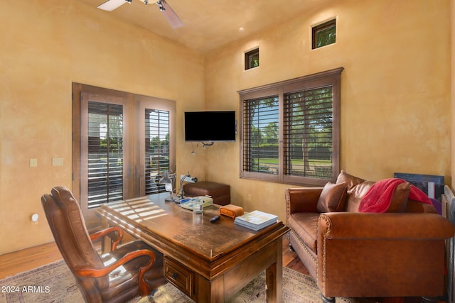 home office featuring ceiling fan and light hardwood / wood-style floors