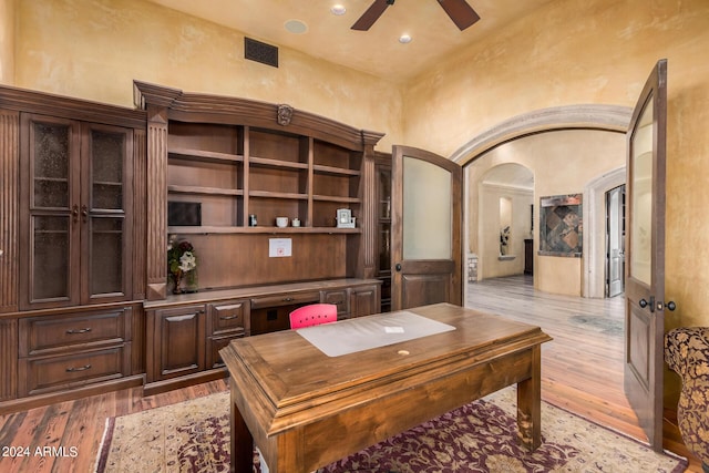 office space with french doors, light wood-type flooring, and ceiling fan