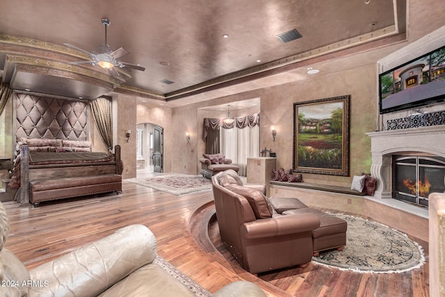 living room with ceiling fan with notable chandelier and hardwood / wood-style flooring