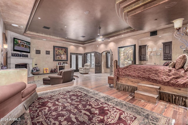 bedroom featuring hardwood / wood-style floors and a tray ceiling