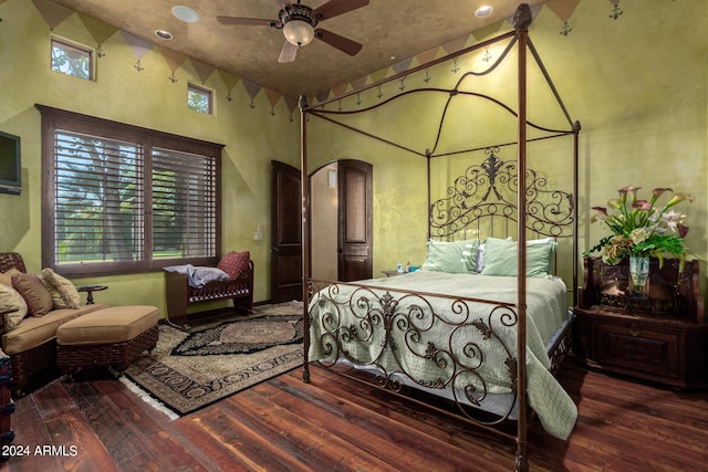 bedroom with ceiling fan and dark hardwood / wood-style flooring