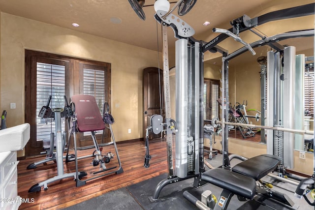 workout area featuring dark wood-type flooring