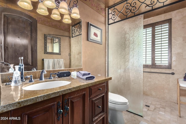 bathroom featuring vanity, toilet, and a tile shower