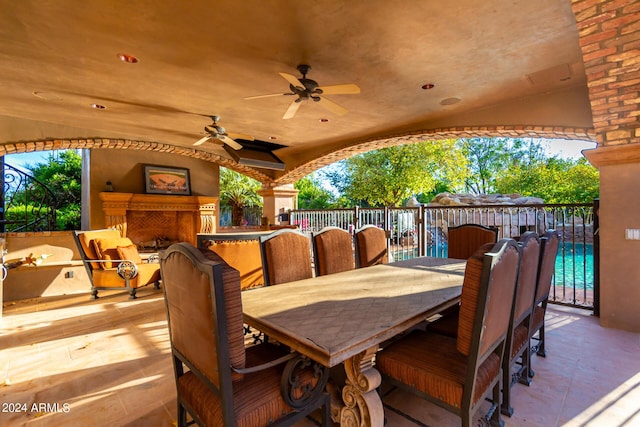 view of patio / terrace with ceiling fan and exterior fireplace