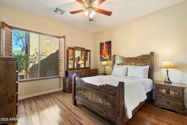 bedroom with ceiling fan and wood-type flooring