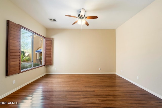 empty room with ceiling fan and dark wood-type flooring