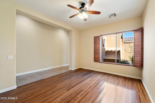 spare room featuring hardwood / wood-style floors and ceiling fan