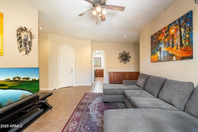 tiled living room featuring ceiling fan