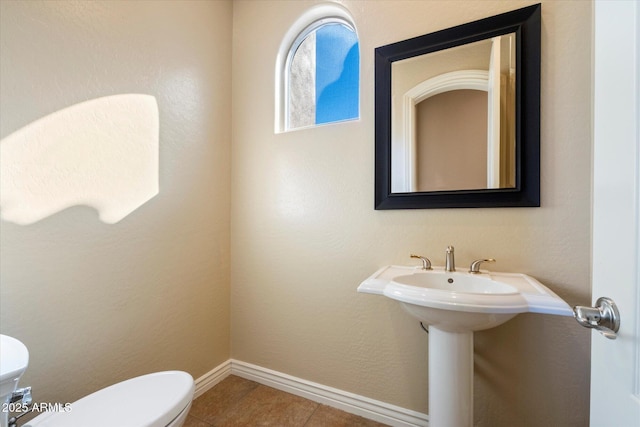 bathroom with tile patterned flooring and toilet