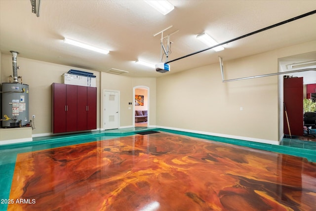 garage featuring gas water heater and a garage door opener