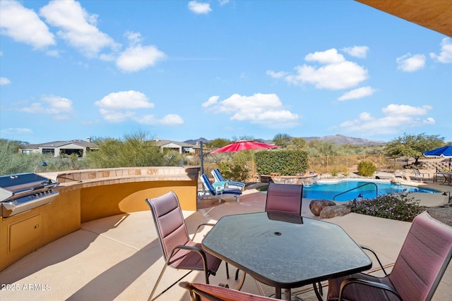 view of patio / terrace featuring a grill and a mountain view