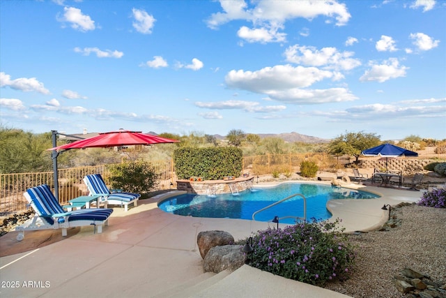 view of swimming pool with pool water feature, a mountain view, a patio, and a hot tub