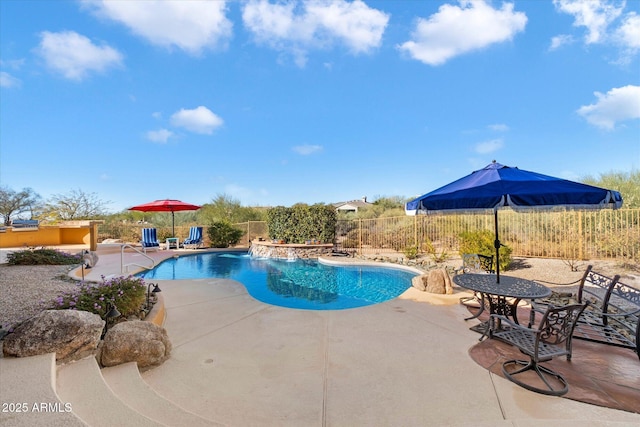 view of pool with a patio and pool water feature