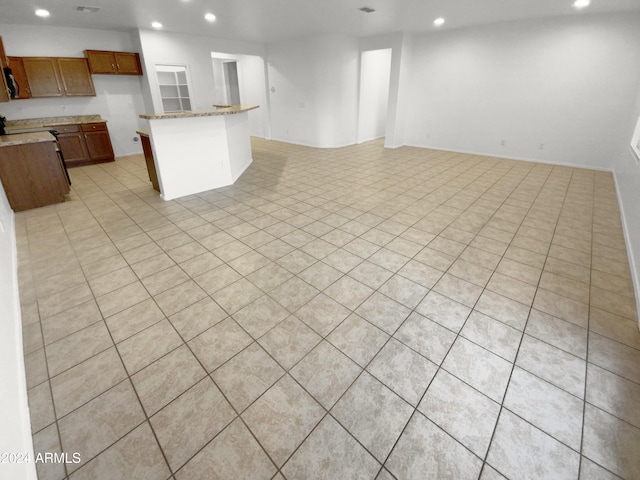 interior space featuring light stone countertops and light tile patterned floors