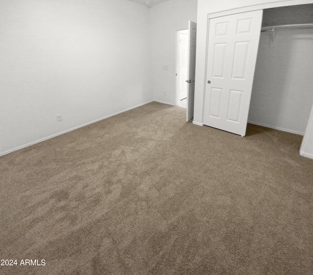 unfurnished bedroom featuring a closet and carpet