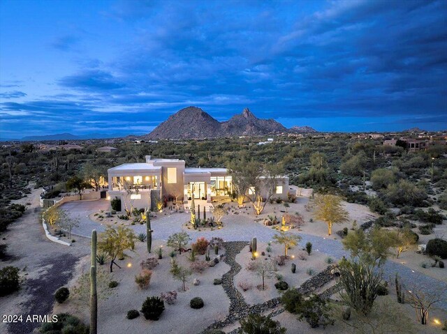 aerial view at dusk featuring a mountain view