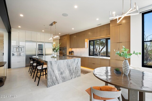 living room featuring ceiling fan and built in features