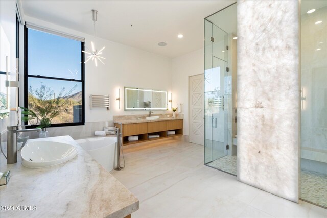 bathroom with a shower with shower door and vanity