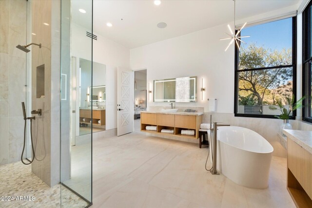 bathroom with a tile shower and vanity