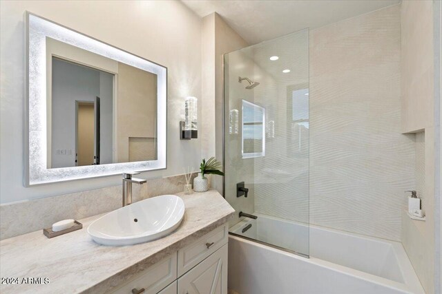 bathroom featuring vanity and an enclosed shower