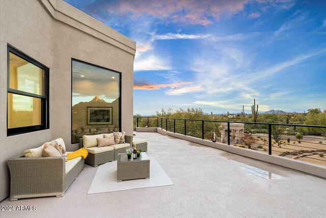 pool at dusk featuring a patio and an in ground hot tub