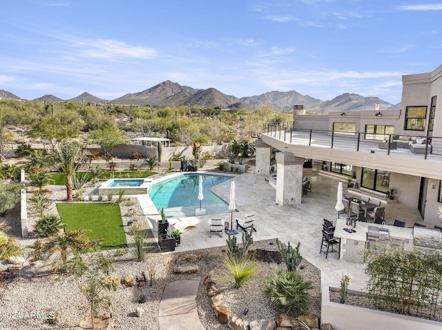 view of swimming pool with a patio and a mountain view