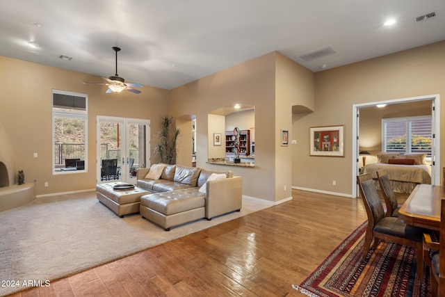 living room featuring a healthy amount of sunlight, light wood-type flooring, and ceiling fan