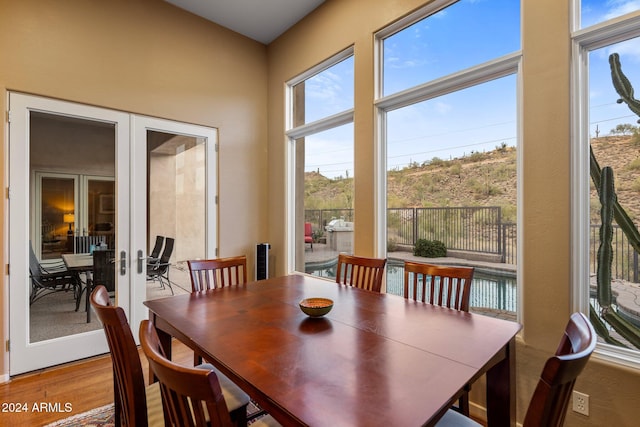 dining area with french doors and hardwood / wood-style floors