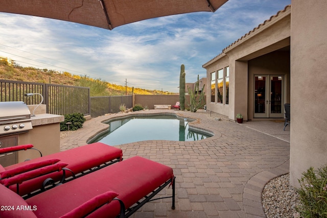 view of swimming pool featuring a patio and french doors