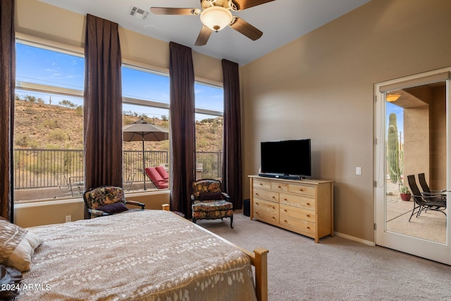 bedroom featuring access to exterior, ceiling fan, multiple windows, and light colored carpet