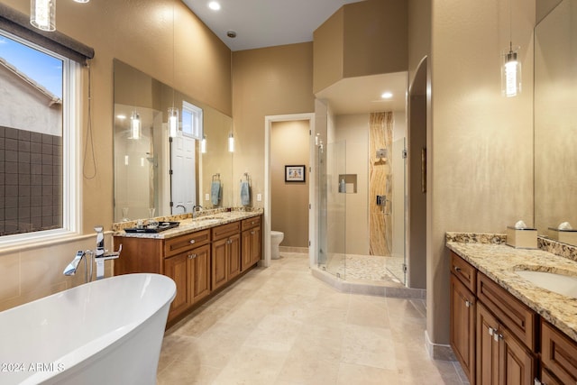 full bathroom featuring toilet, plus walk in shower, vanity, and tile patterned floors