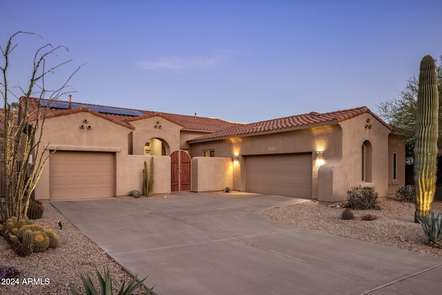 mediterranean / spanish-style home featuring a garage