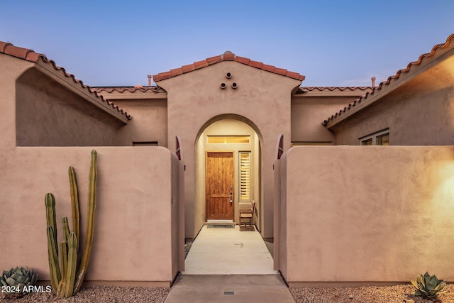 view of exterior entry at dusk