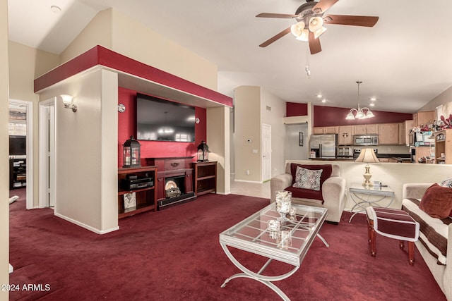 living room with high vaulted ceiling, ceiling fan with notable chandelier, and dark colored carpet