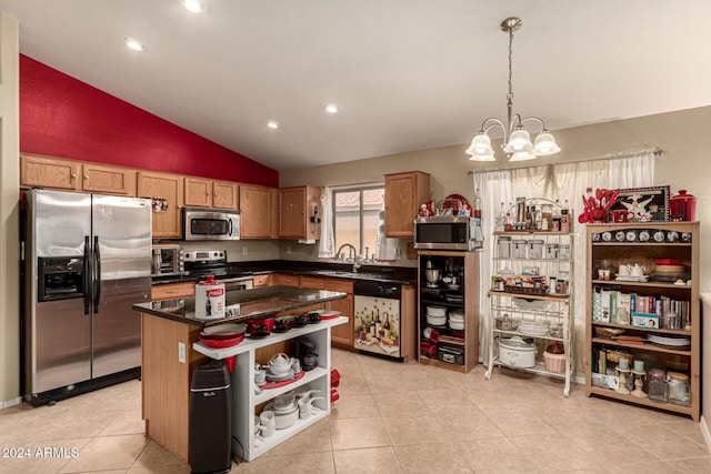 kitchen featuring a center island, lofted ceiling, sink, a notable chandelier, and stainless steel appliances