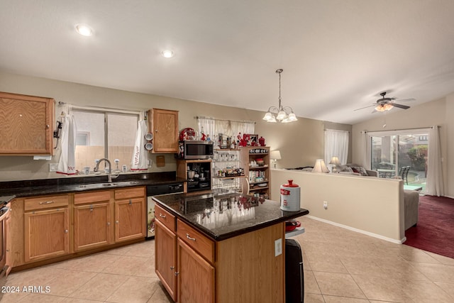 kitchen featuring ceiling fan with notable chandelier, vaulted ceiling, sink, light tile patterned floors, and dishwasher