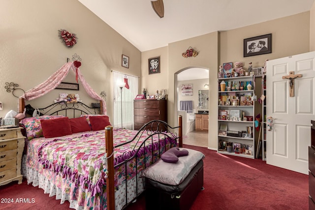 carpeted bedroom with ceiling fan, ensuite bathroom, and high vaulted ceiling