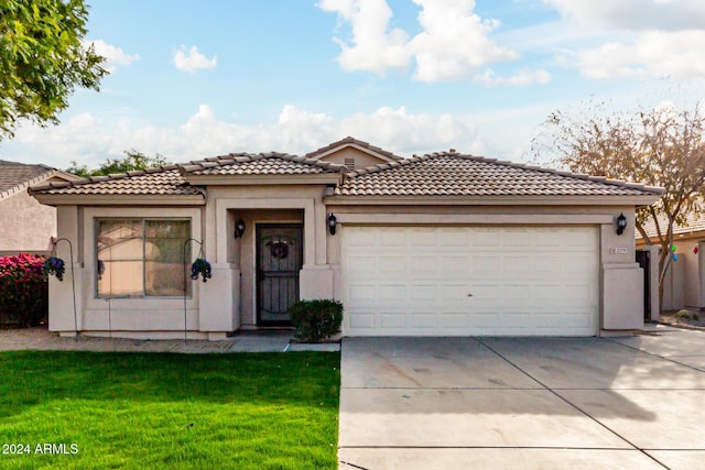 view of front of home featuring a garage and a front lawn